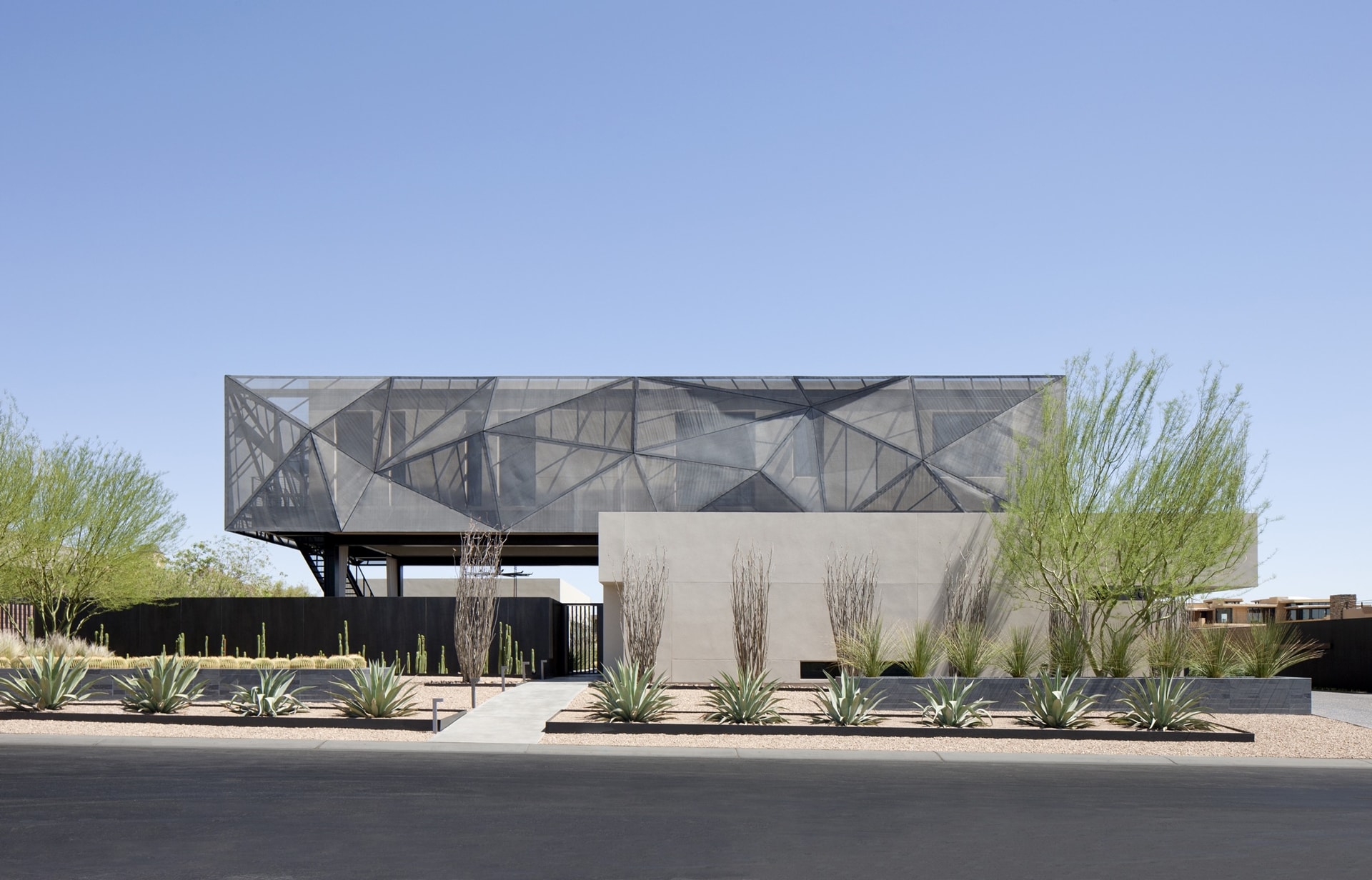 Street view of modern desert house designed by assemblageSTUDIO