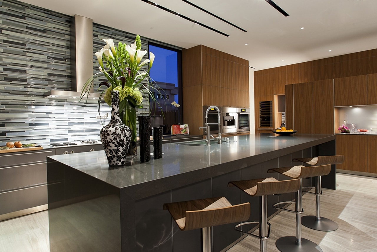 Black kitchen island in modern desert house designed by assemblageSTUDIO