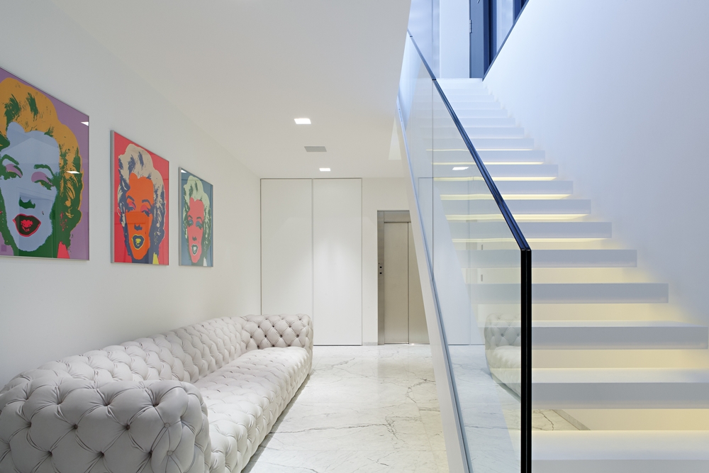 Modern staircase and white sofa in House M
