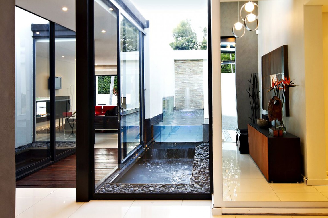 Glass walls in renovated Mosi residence by Nico van der Meulen Architects