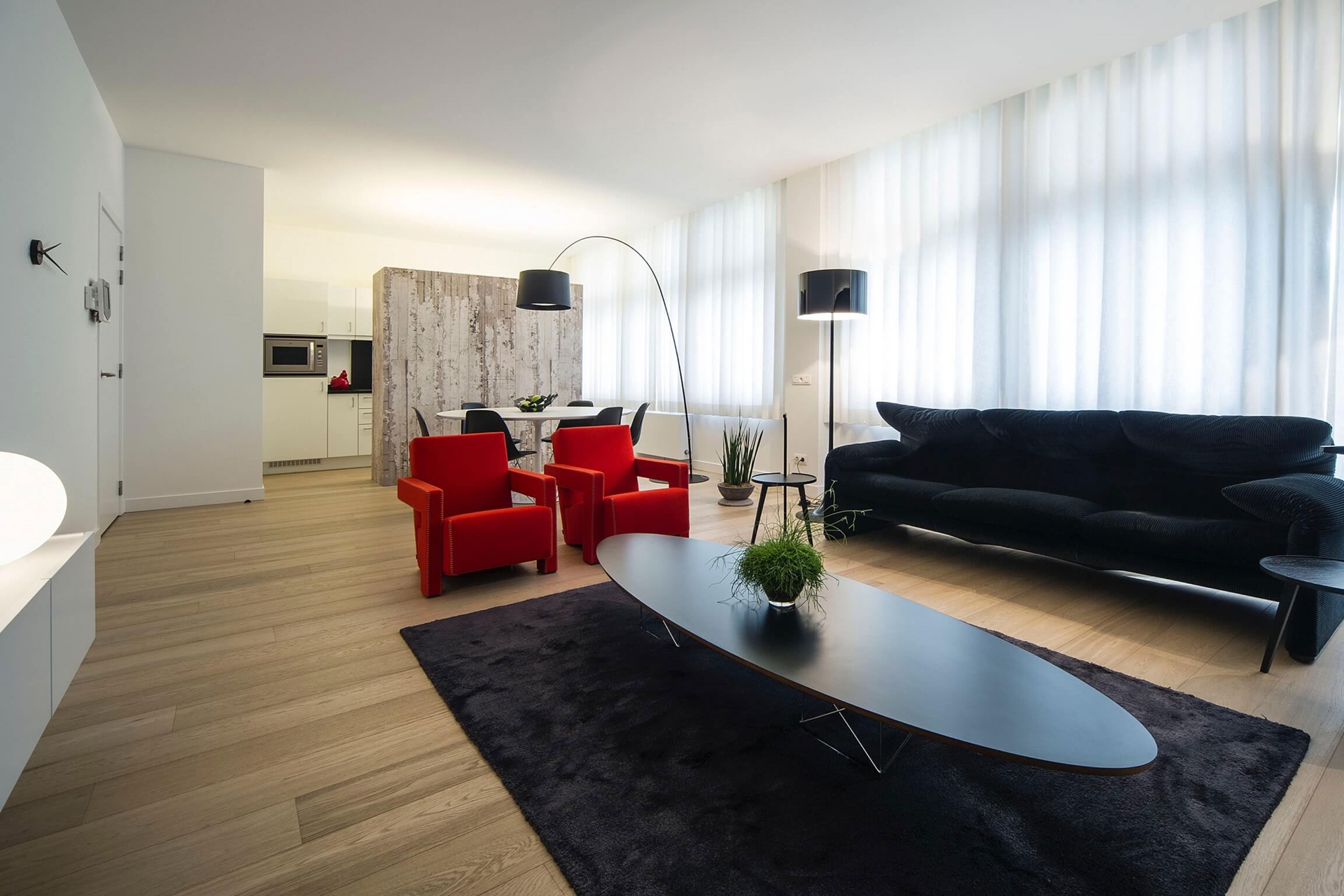 Living room in minimalist apartment by Filip Deslee