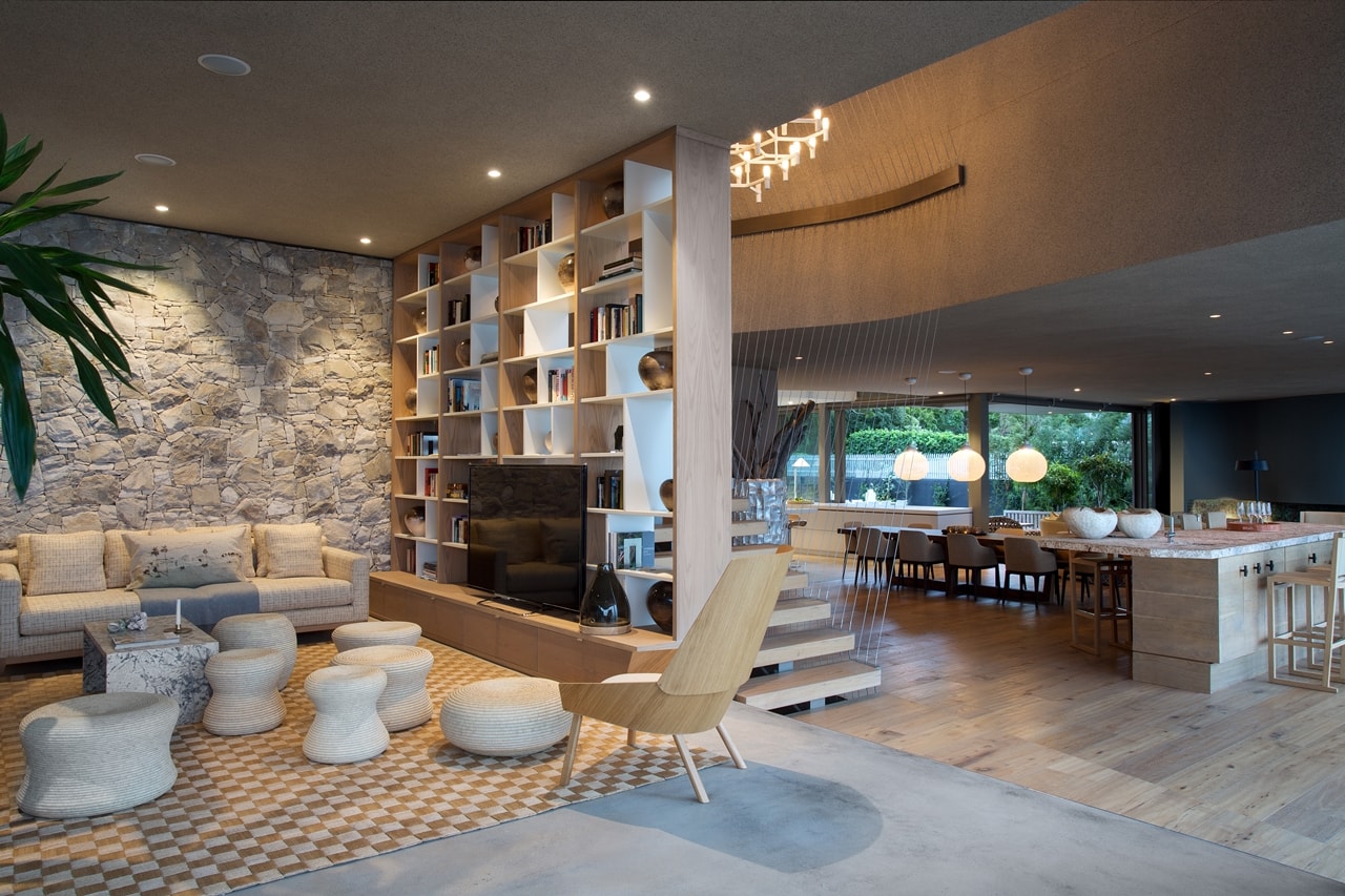 Living room in modern home with wooden facade by SAOTA