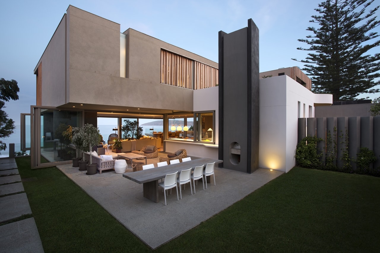 Outdoor terrace and modern home with wooden facade by SAOTA