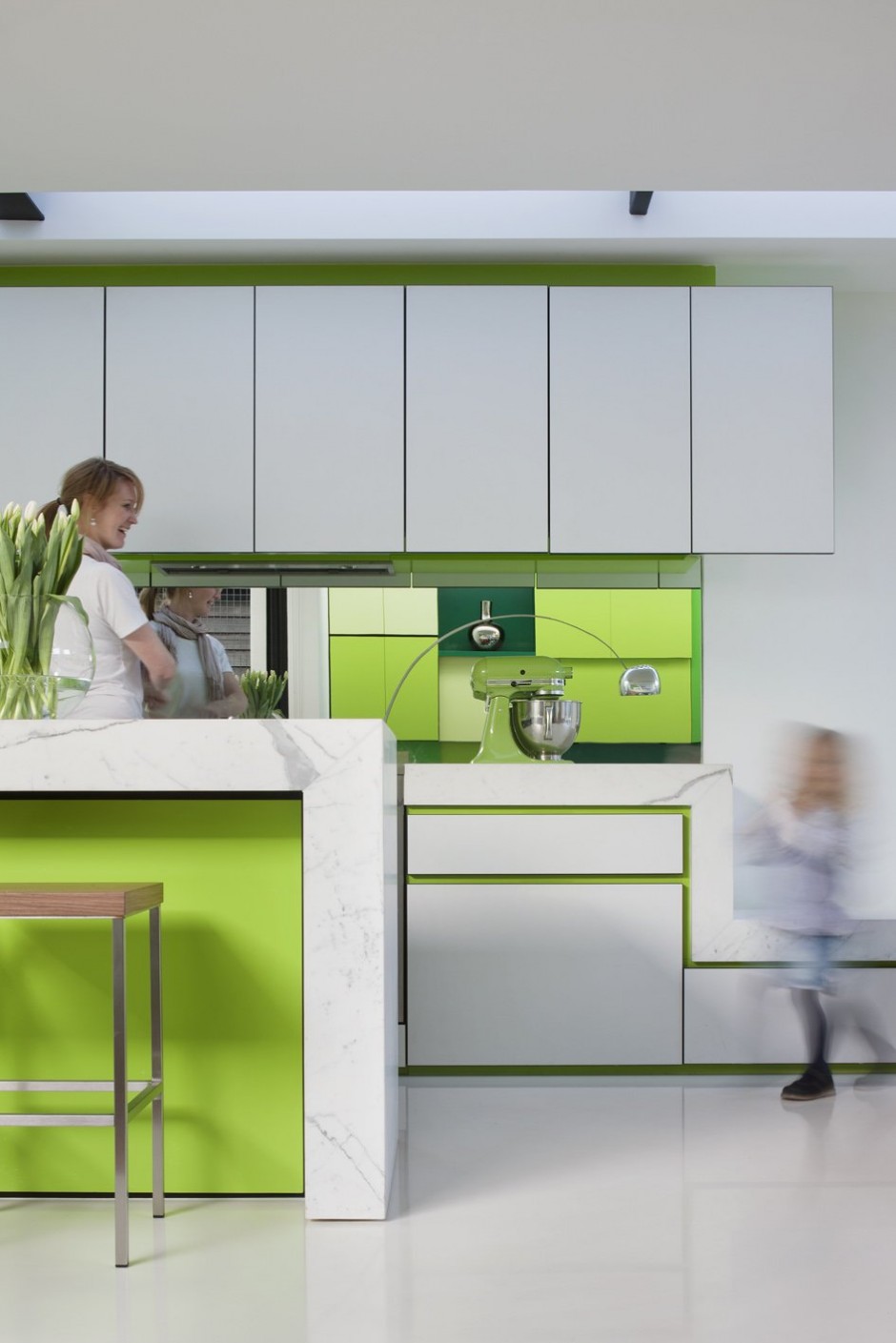 Small kitchen with green and white cabinets