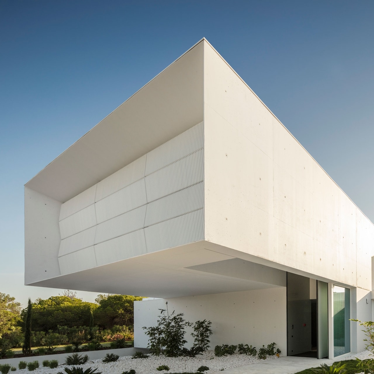 Cantilevered deck above modern entrance