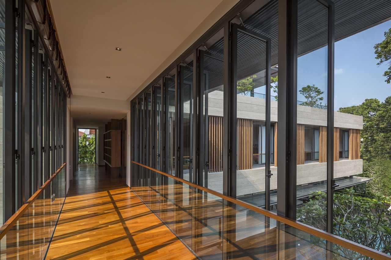 Glass walls inside the bridge in modern mansion designed by Wallflower Architecture and Design