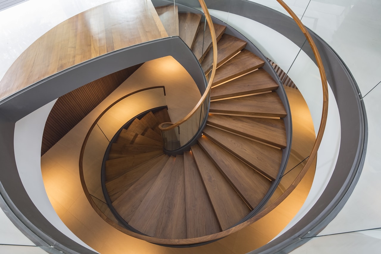 Spiral staircase in modern mansion designed by Wallflower Architecture and Design