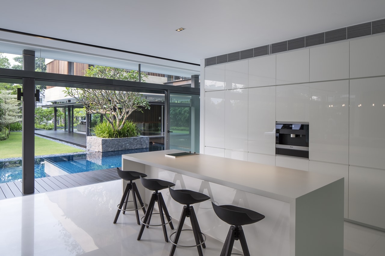 White minimalist kitchen in modern mansion designed by Wallflower Architecture and Design