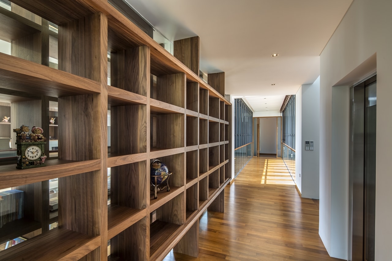 Wooden shelves in modern mansion designed by Wallflower Architecture and Design