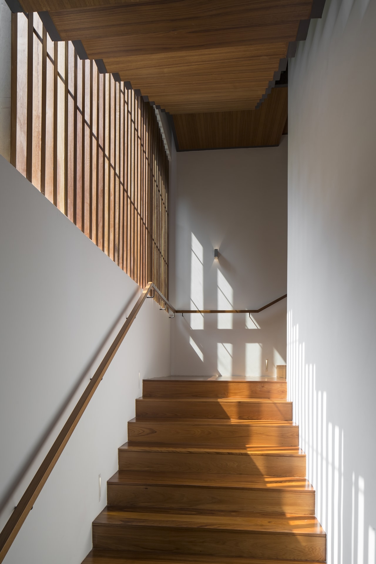 Wooden staircase in modern mansion designed by Wallflower Architecture and Design