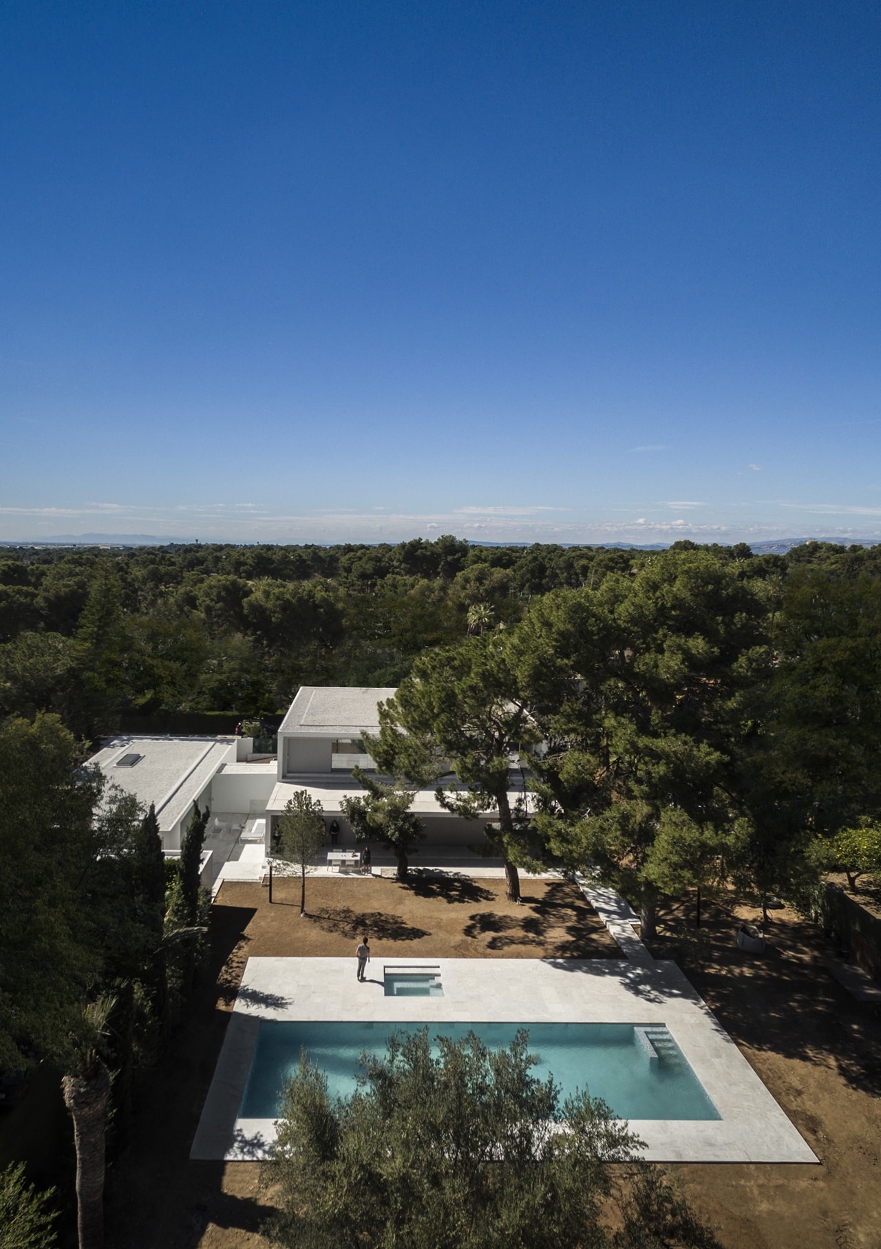 Backyard swimming pool in minimalist house designed by Fran Silvestre Architects