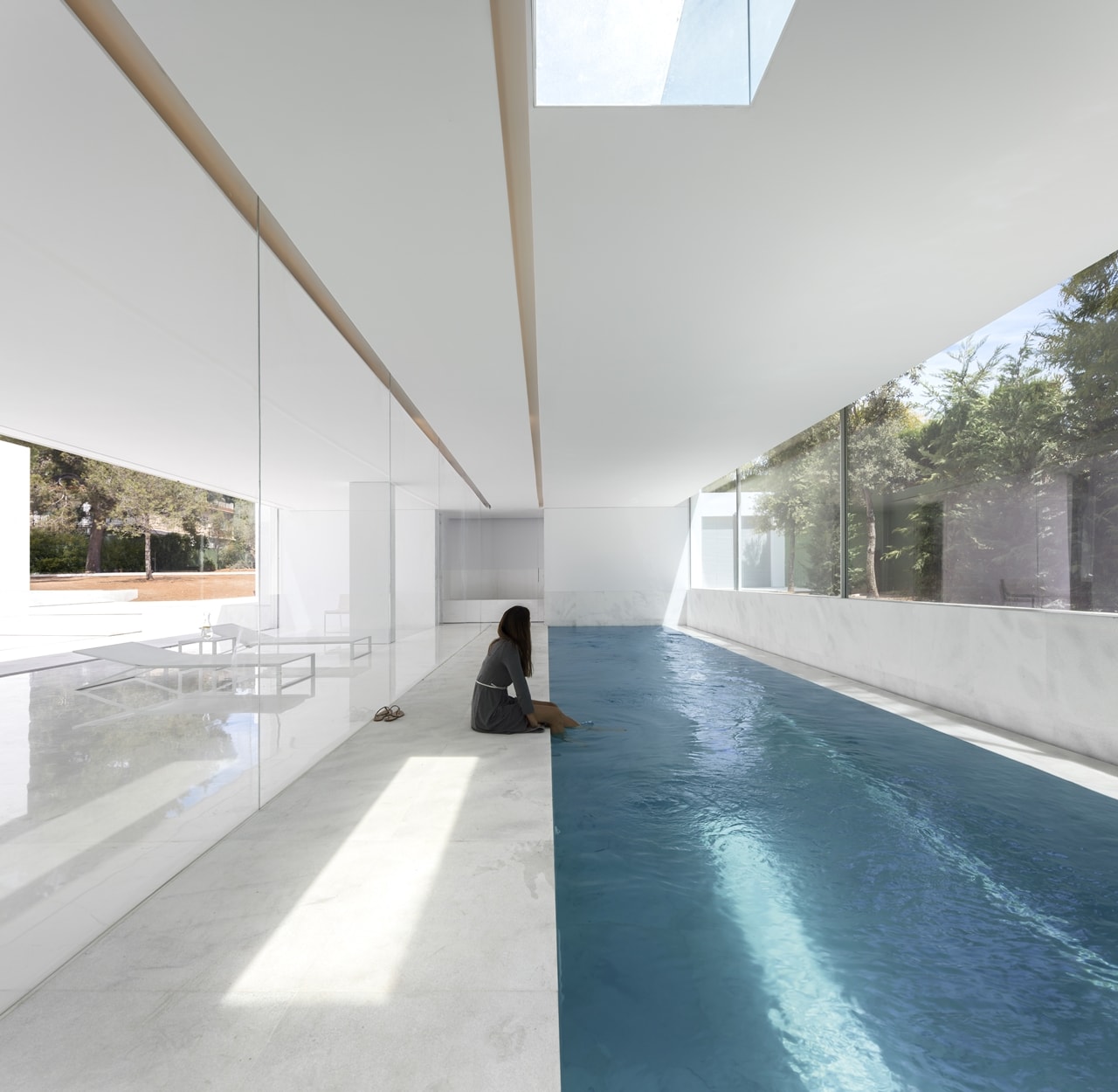 Indoor swimming pool in minimalist house designed by Fran Silvestre Architects