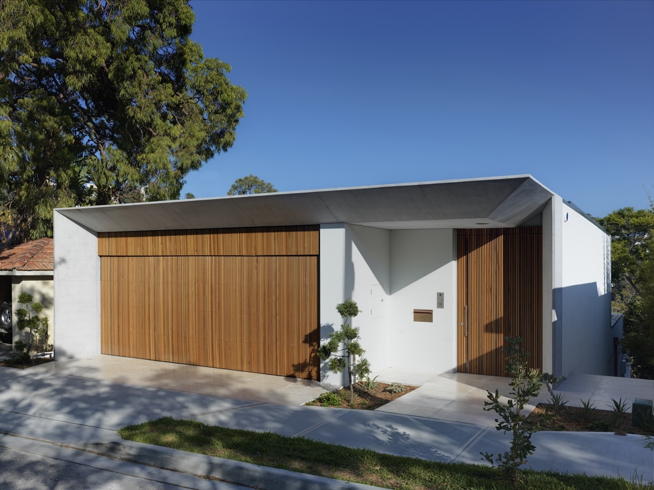 Street level facade of the hillside house designed by Rolf Ockert