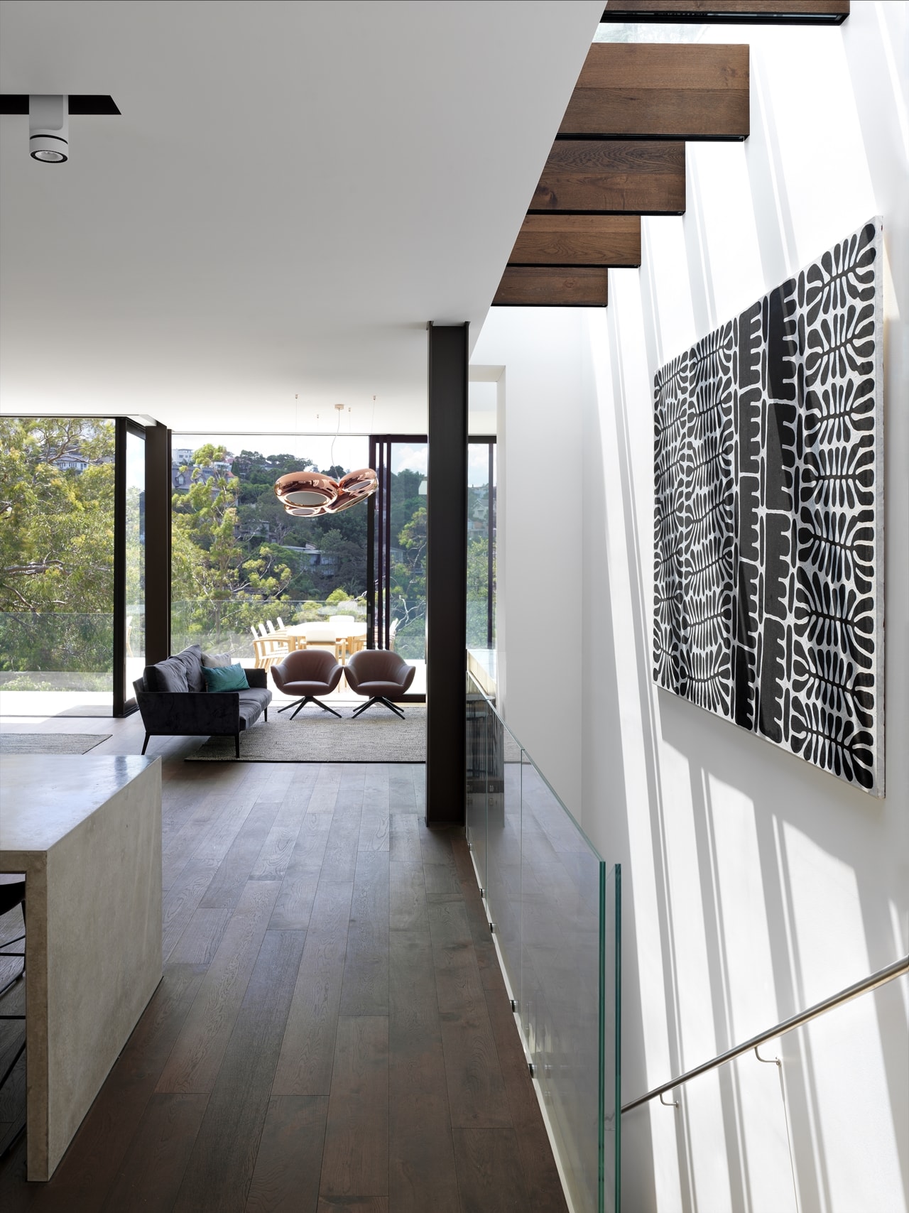 Staircase glass belustrade in a hillside house designed by Rolf Ockert