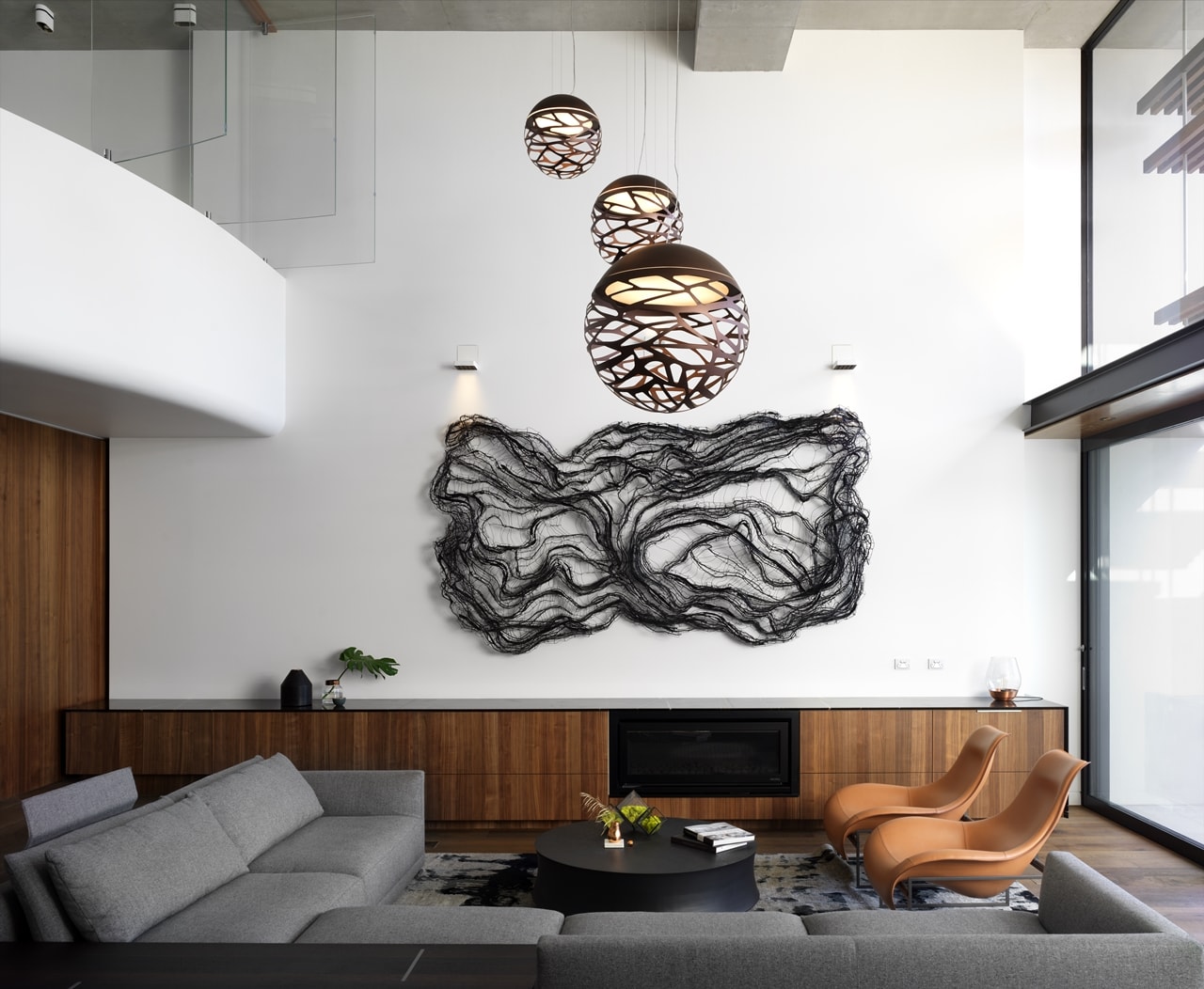 Double height living room wall design in a hillside house designed by Rolf Ockert