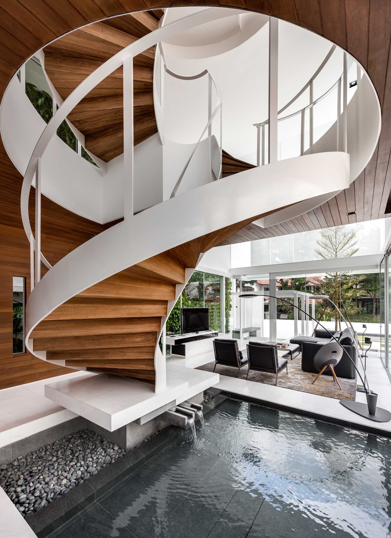 Curved staircase with indoor pond designed by Park Associates Architects