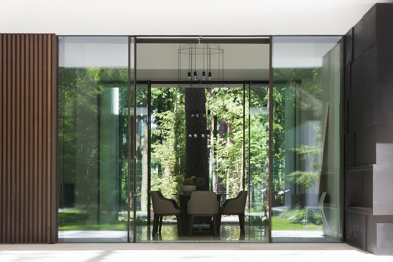 Glass doors of modern forest house designed by Alexandra Fedorova